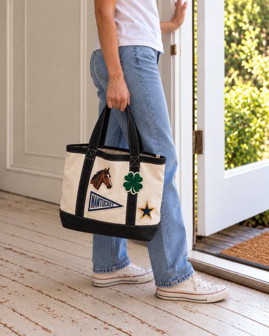 Woman carrying a custom canvas tote bag with embroidered logo patches