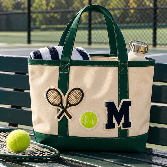 Monogrammed green canvas tote bag with tennis rackets, tennis ball and navy letter M patches